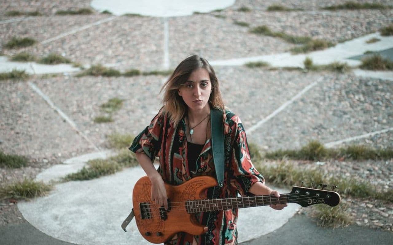 Luna Škopelja outdoors with her Luna bass guitar